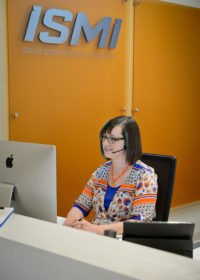 Female receptionist at the front desk of ISMI.