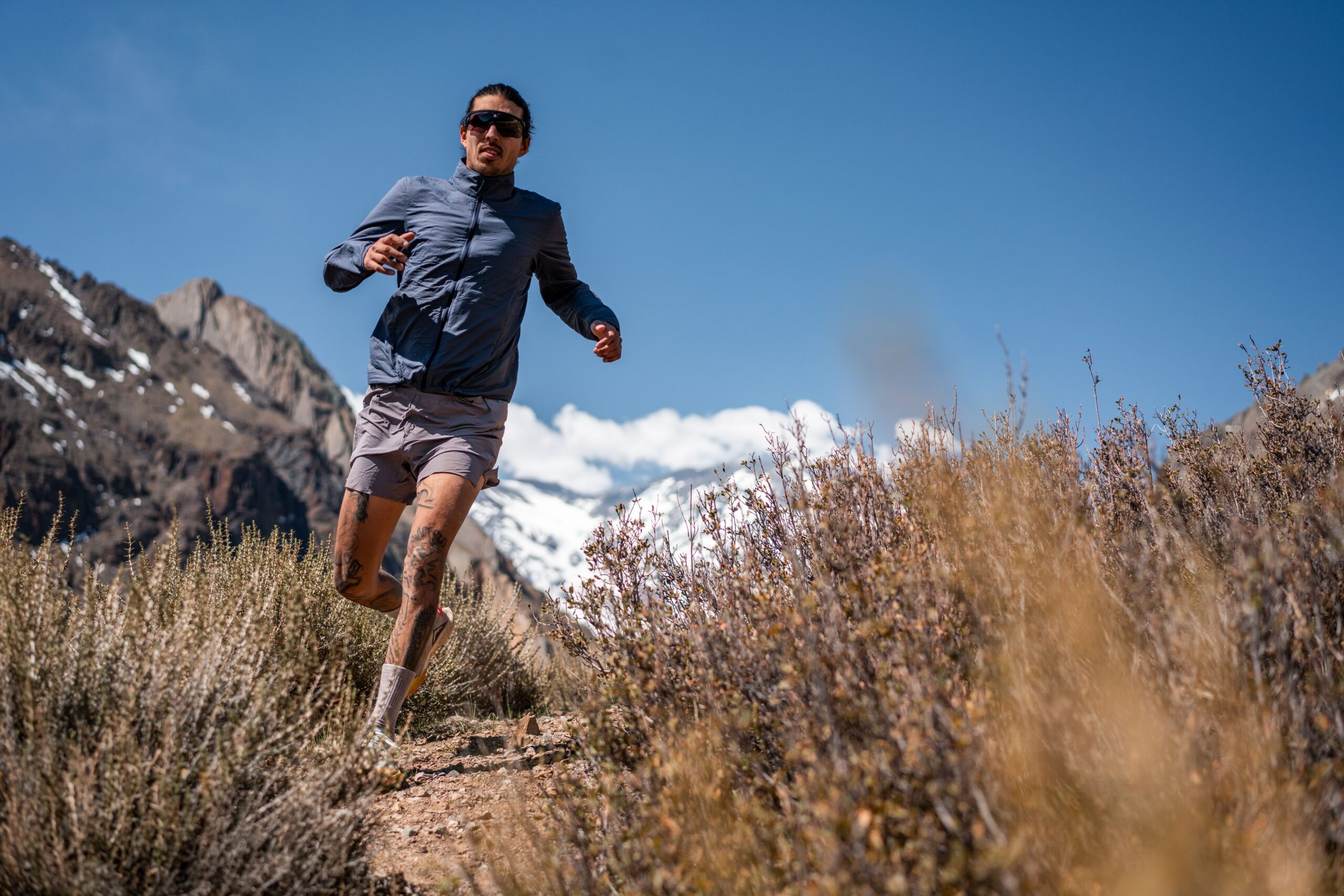 trail runner in the high desert mountains|achilles tendon diagram|ankle sprain diagram|glute diagram|it band diagram|plantar fasciitis diagram|shin diagram